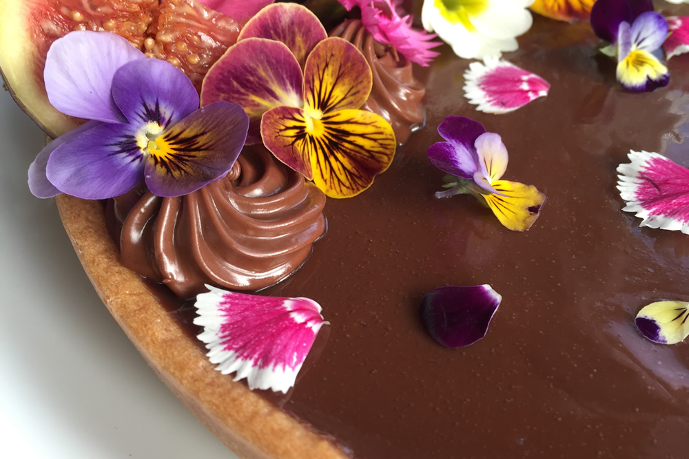 Chocolate tart with edible flowers